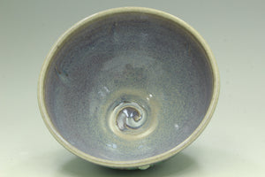 Ceramic bowl with a textured surface on a light gray background