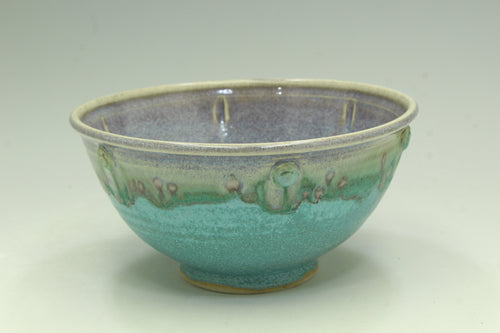 Ceramic bowl with a two-tone glaze on a light background