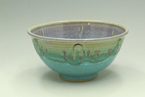 Ceramic bowl with decorative glaze on a plain background