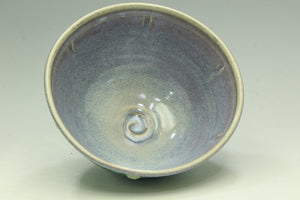 Ceramic bowl with a textured surface on a light gray background