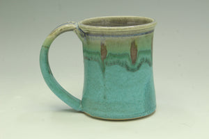 Green ceramic mug on a light gray background