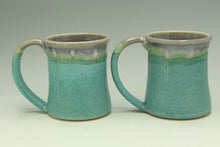 Load image into Gallery viewer, Two turquoise ceramic mugs with a grayish-brown rim on a light gray background