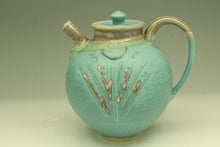 Load image into Gallery viewer, Turquoise ceramic teapot with decorative elements on a beige background