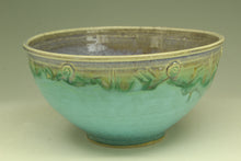 Load image into Gallery viewer, Turquoise ceramic bowl with decorative rim on a beige background