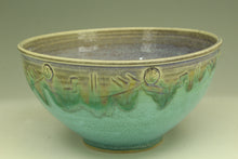 Load image into Gallery viewer, Green ceramic bowl with decorative patterns on a beige background