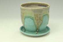 Load image into Gallery viewer, Green ceramic planter with a matching saucer on a light background