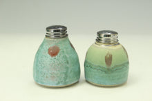 Load image into Gallery viewer, Two ceramic salt and pepper shakers with decorative patterns on a light background
