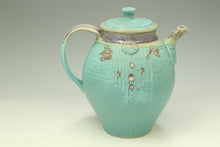 Load image into Gallery viewer, Turquoise ceramic teapot with decorative elements on a light gray background