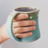 Holding a mugs